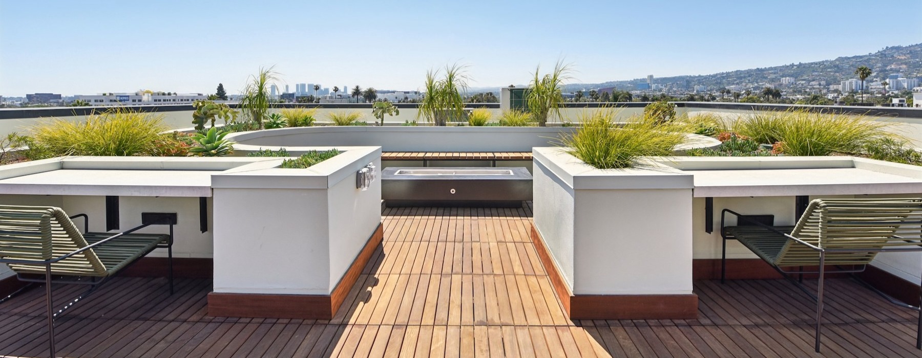a deck with white tables, chairs and trees