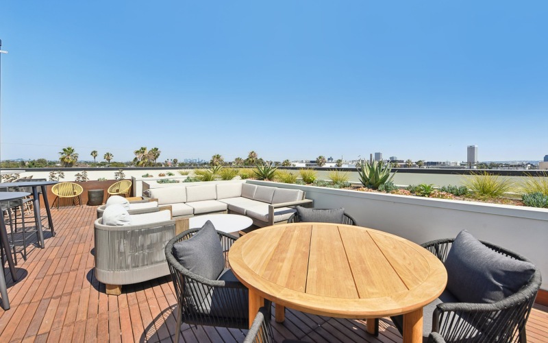 a patio with tables, chairs and couches