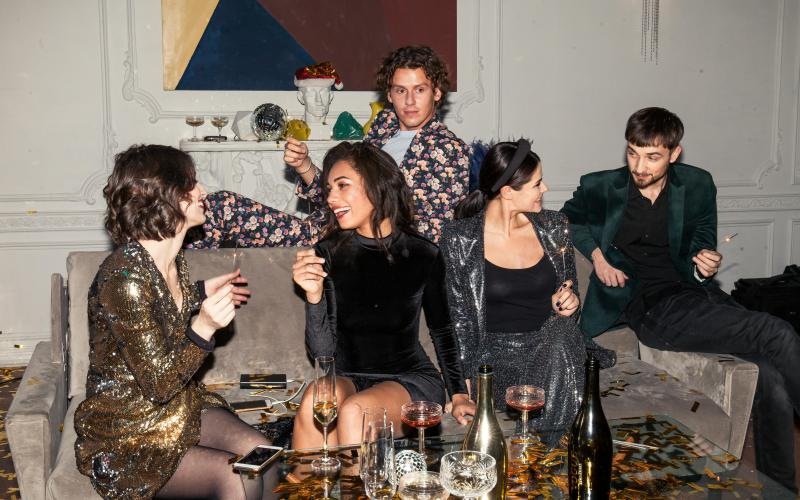 a group of people sitting around a table with drinks